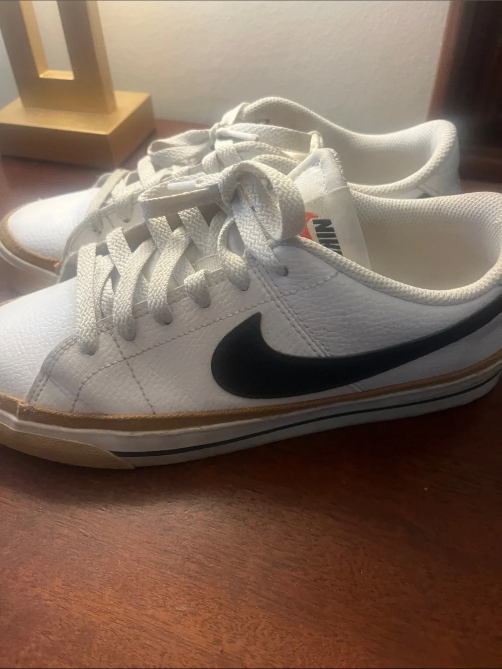 Nike White Sneakers with Black Swoosh and Tan Accent